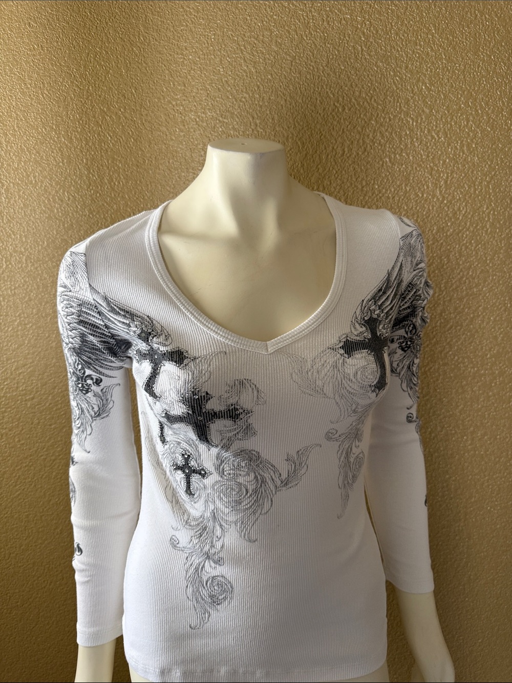 Vocal White Ribbed V-Neck Long Sleeve Top with Black Graphic Crosses